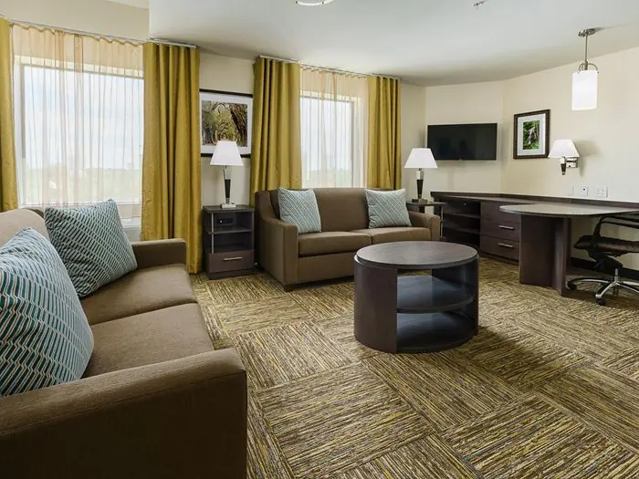 Living room with sofas, TV and desk.