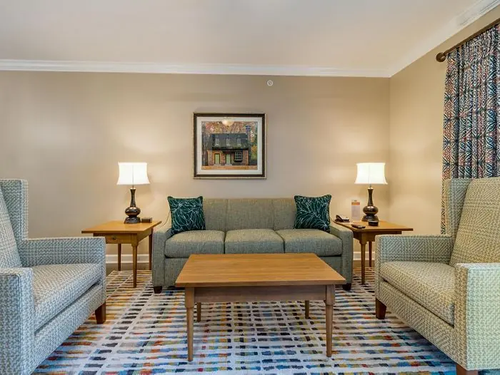 Living room with sofa, two armchairs and coffee table.